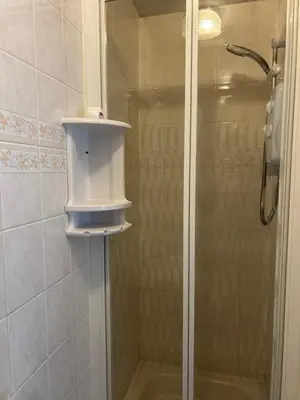 a bathroom with a shower with a glass door at Cadeby Lodge in Blackpool