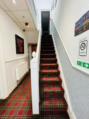 a staircase in a building with a red carpet at Cadeby Lodge in Blackpool