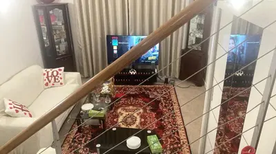a living room with a table and a video game at Chic & Central Liverpool Flat in Liverpool
