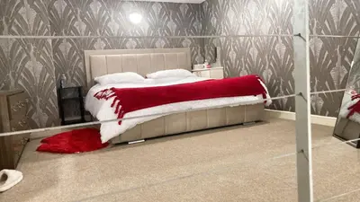 a bedroom with a bed with a red blanket on it at Chic & Central Liverpool Flat in Liverpool