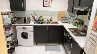 a kitchen with a washing machine and a dishwasher at Chic & Central Liverpool Flat in Liverpool