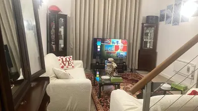 a living room with a couch and a tv at Chic & Central Liverpool Flat in Liverpool