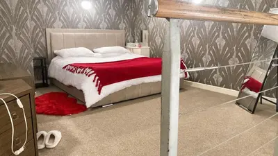a bedroom with a bed with a red blanket at Chic & Central Liverpool Flat in Liverpool