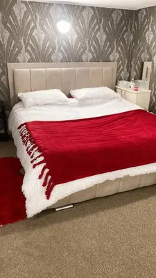 a bed with a red and white blanket on it at Chic & Central Liverpool Flat in Liverpool