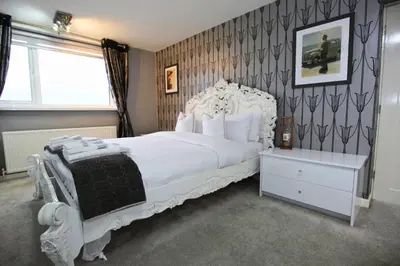 a bedroom with a large white bed and a window at Family Escape, Blackpool Attractions Nearby coast in Poulton le Fylde