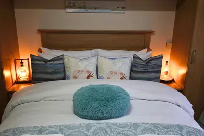 a blue ball on top of a bed with pillows at Family Escape, Blackpool Attractions Nearby coast in Poulton le Fylde