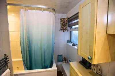 a bathroom with a shower with a blue shower curtain at Family Escape, Blackpool Attractions Nearby coast in Poulton le Fylde