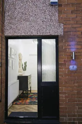 a brick wall with a black door in a room at Family Escape, Blackpool Attractions Nearby coast in Poulton le Fylde