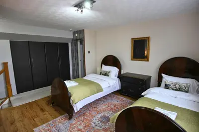 a bedroom with two beds and a rug at Family Escape, Blackpool Attractions Nearby coast in Poulton le Fylde