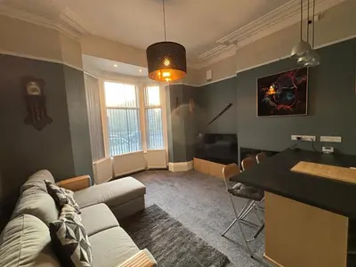 a living room with a couch and a table at Louise Suite in Southport