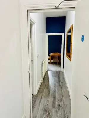 an empty hallway with a table in a dining room at Michaels Suite in Southport