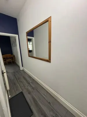 an empty room with a mirror on a wall at Michaels Suite in Southport