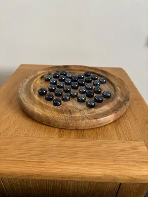 a wooden plate with blueberries on top of a table at Michaels Suite in Southport