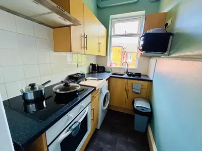 a small kitchen with two pots on the stove at Michaels Suite in Southport