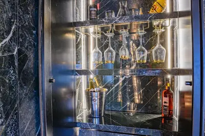 a glass cabinet with bottles and a bottle at Brierley Club Hideaway Chic 7 Star Retreat in Rishton