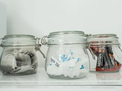 three jars on a shelf with paper in them at Pass the Keys Cosy Liverpool Home. WiFi Parking Nr Alder Hey in Liverpool