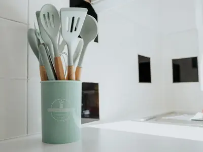 a cup filled with utensils sitting on a counter at Pass the Keys Cosy Liverpool Home. WiFi Parking Nr Alder Hey in Liverpool