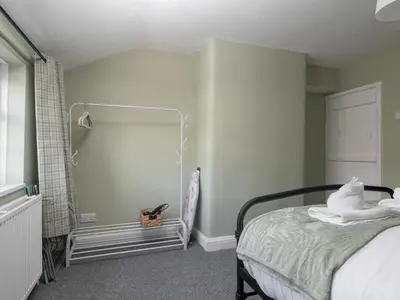 a bedroom with a bed and a shower at Pass the Keys Cosy Liverpool Home. WiFi Parking Nr Alder Hey in Liverpool