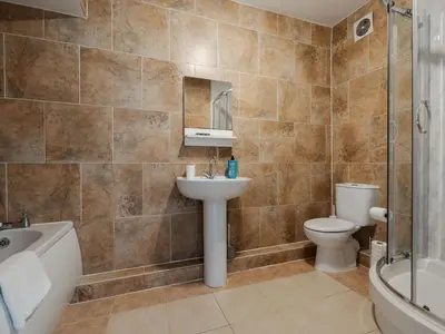 a bathroom with a sink and a toilet and a shower at Pass the Keys Cosy Liverpool Home. WiFi Parking Nr Alder Hey in Liverpool