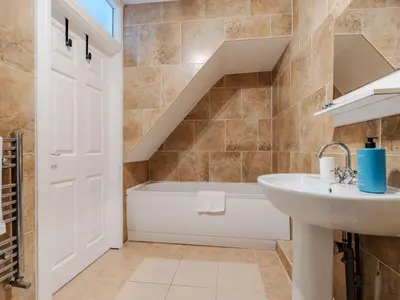 a bathroom with a sink and a bath tub at Pass the Keys Cosy Liverpool Home. WiFi Parking Nr Alder Hey in Liverpool