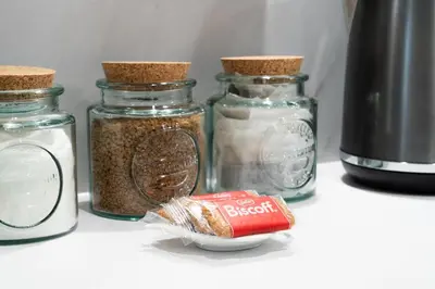 a group of glass jars with spices on a counter at Luxury Waterfront Apartment - Liverpool City Centre - Sleeps 4 in Liverpool