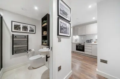 a white bathroom with a toilet and a sink at Luxury Waterfront Apartment - Liverpool City Centre - Sleeps 4 in Liverpool