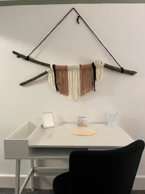 an office with a desk with a dream catcher on the wall at The Bohe Home in Wallasey