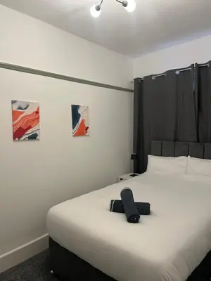 a bedroom with a bed with a stuffed animal on it at The Bohe Home in Wallasey