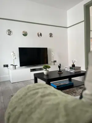 a living room with a flat screen tv on a wall at The Bohe Home in Wallasey