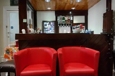 two red chairs sitting next to a bar at Cardoh Lodge in Blackpool