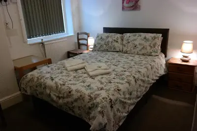 a bedroom with a bed with two pillows on it at Cardoh Lodge in Blackpool