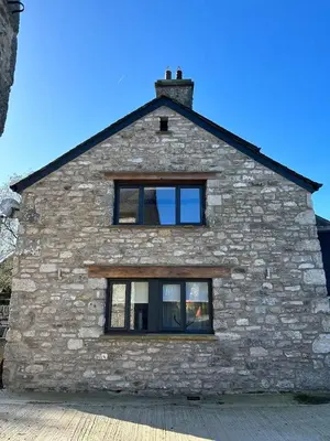 a stone house with a window on the side of it at The Tractor House in Great Urswick