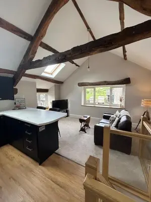 a large living room with a table and a couch at The Tractor House in Great Urswick