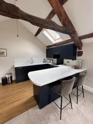 a kitchen with a large white island in a room at The Tractor House in Great Urswick