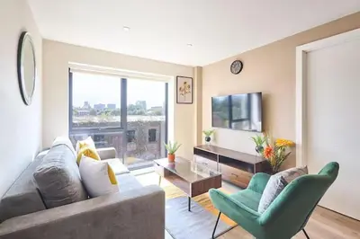 a living room with a couch and a tv at 2 Bed - Sleeps 6 - Parking - City Centre in Liverpool