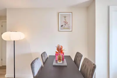a dining room with a black table and chairs at 2 Bed - Sleeps 6 - Parking - City Centre in Liverpool