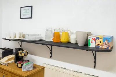 a shelf on the wall with some drinks on it at Rest and Welcome B&B, Blackpool in Blackpool