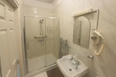 a bathroom with a shower and a sink at Rest and Welcome B&B, Blackpool in Blackpool