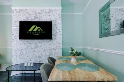 a dining room with a wooden table and chairs at Skipton House Business Travel Accommodation Parking Liverpool in Liverpool