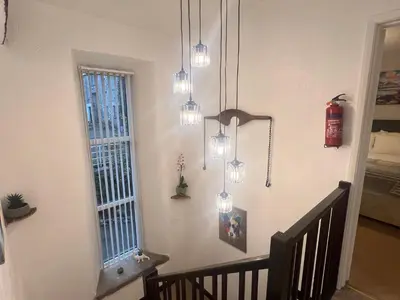 a room with lights hanging from a wall at The Old Farmhouse at Brackenthwaite Farm in Carnforth