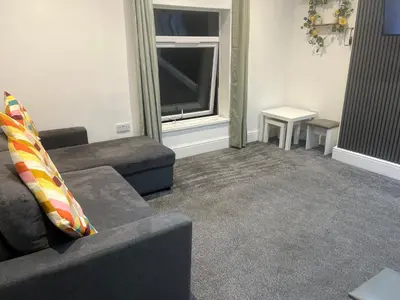 a living room with a couch and a television at Crosby Marina Apartment in Waterloo