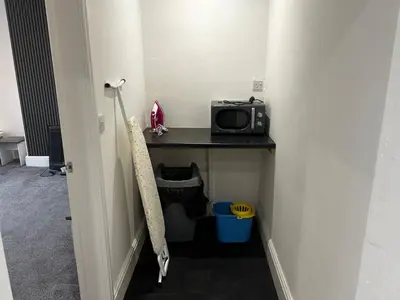 a room with a desk with a microwave on a table at Crosby Marina Apartment in Waterloo