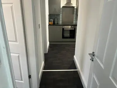 a hallway leading to a kitchen with a stove at Crosby Marina Apartment in Waterloo