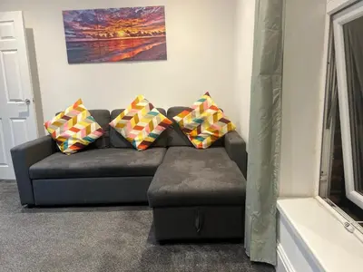 a couch with four pillows on it in a living room at Crosby Marina Apartment in Waterloo