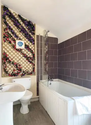 a bathroom with a tub and a toilet and a sink at The Docklands XL by Serviced Living Liverpool in Liverpool