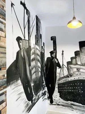 a painting of two men walking next to a boat at The Docklands XL by Serviced Living Liverpool in Liverpool