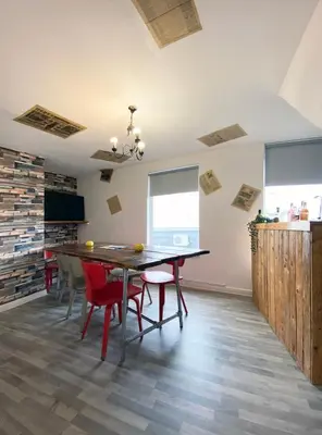 a dining room with a wooden table and chairs at The Docklands XL by Serviced Living Liverpool in Liverpool