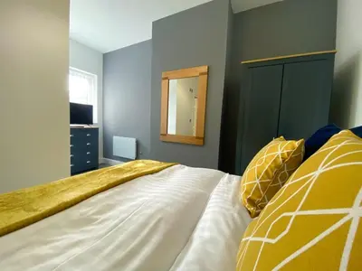 a bedroom with a bed and a mirror at Full Private House Sleeping Up To 18 - Close To Seafront in Blackpool