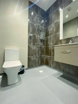 a bathroom with a toilet and a shower at Full Private House Sleeping Up To 18 - Close To Seafront in Blackpool