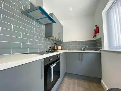 a kitchen with a sink and a dishwasher at Full Private House Sleeping Up To 18 - Close To Seafront in Blackpool